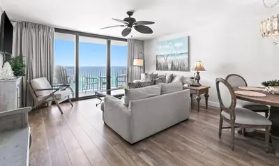 a living room with a couch and a dining room with a table at One Seagrove Place 0704 in Santa Rosa Beach