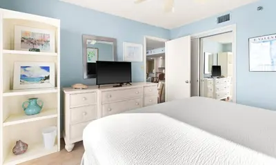 a bedroom with a bed and a tv on a dresser at One Seagrove Place 1103 in Santa Rosa Beach