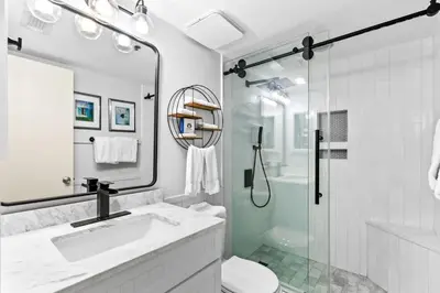 a white bathroom with a sink and a shower at One Seagrove Place 1103 in Santa Rosa Beach