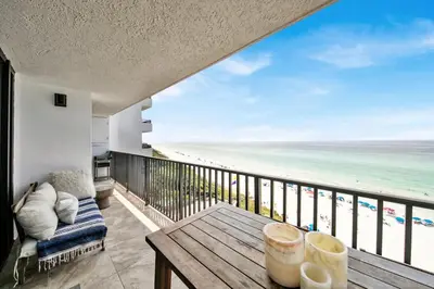 a balcony with a table and a view of the beach at One Seagrove Place 0804 in Santa Rosa Beach
