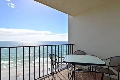a balcony with a table and chairs and the ocean at One Seagrove Place 1001 in Santa Rosa Beach