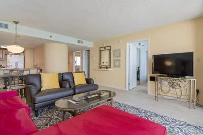 a living room with a couch and a tv at One Seagrove Place 1001 in Santa Rosa Beach