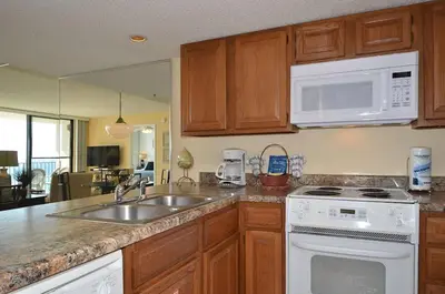 a kitchen with a sink and a stove and microwave at One Seagrove Place 1001 in Santa Rosa Beach