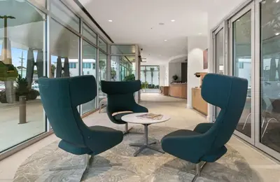 two chairs and a table in a room with windows at One Seagrove Place 1406 in Santa Rosa Beach