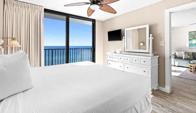 a bedroom with a white bed and a large window at One Seagrove Place 1004 in Santa Rosa Beach