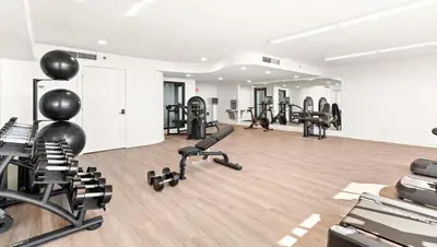 a gym with several treadmills and exercise bikes at One Seagrove Place 1004 in Santa Rosa Beach