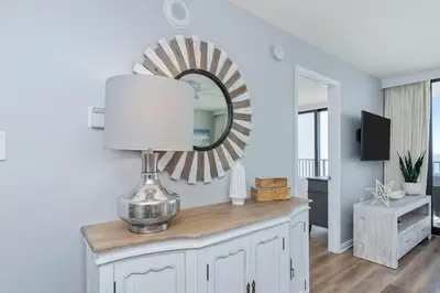 a mirror on top of a dresser in a living room at One Seagrove Place 0807 in Santa Rosa Beach