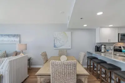 a kitchen with a wooden table and chairs at One Seagrove Place 0807 in Santa Rosa Beach