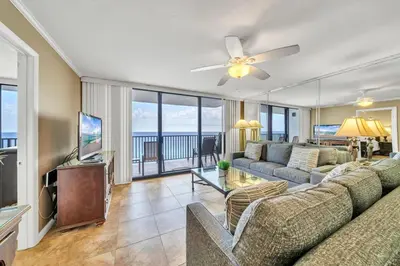 a living room with a couch and a flat screen tv at One Seagrove Place 1408 in Santa Rosa Beach