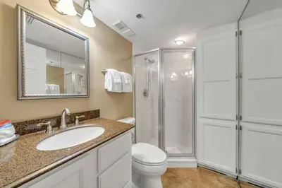 a bathroom with a toilet and a sink and a shower at One Seagrove Place 1408 in Santa Rosa Beach