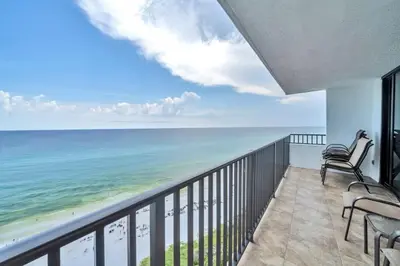 a balcony with chairs and a view of the ocean at One Seagrove Place 1408 in Santa Rosa Beach
