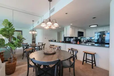 a kitchen and dining room with a table and chairs at One Seagrove Place 1208 in Santa Rosa Beach