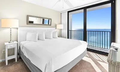 a bedroom with a white bed and a large window at One Seagrove Place 1208 in Santa Rosa Beach