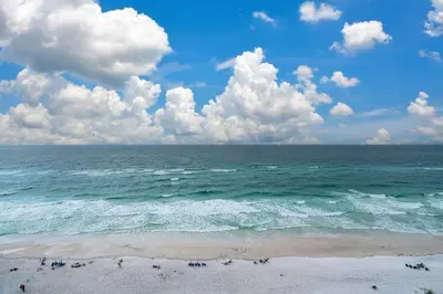 a view of the ocean with people on the beach at One Seagrove Place 1208 in Santa Rosa Beach