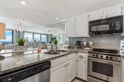 a kitchen with white cabinets and a counter top at One Seagrove Place 0902 in Santa Rosa Beach