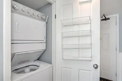 a white laundry room with a washer and dryer at One Seagrove Place 0902 in Santa Rosa Beach