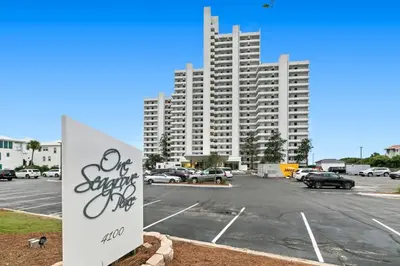 a parking lot with a large building in the background at One Seagrove Place 0902 in Santa Rosa Beach