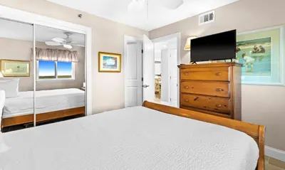 a bedroom with a bed and a tv on a dresser at One Seagrove Place 1303 in Santa Rosa Beach