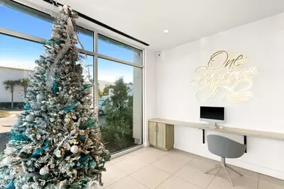 a christmas tree in a room with a desk at One Seagrove Place 1303 in Santa Rosa Beach