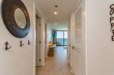 a hallway with a mirror on the wall and a hallway with a hallway at One Seagrove Place 1302 in Santa Rosa Beach