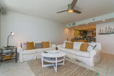 a living room with two white couches and a table at One Seagrove Place 1302 in Santa Rosa Beach
