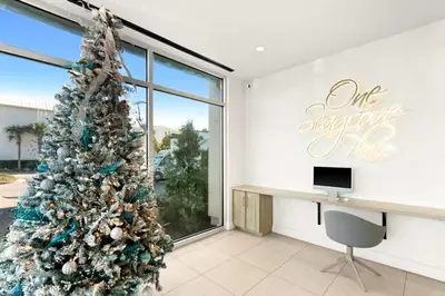 a christmas tree in a room with a desk at One Seagrove Place 1302 in Santa Rosa Beach