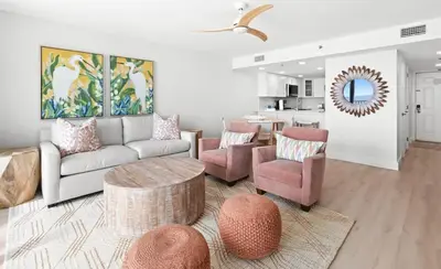 a living room with a couch and chairs and a table at One Seagrove Place 1203 in Santa Rosa Beach