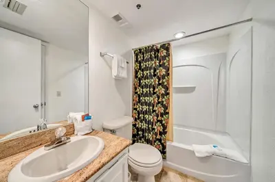 a bathroom with a sink and a toilet and a shower at One Seagrove Place 1306 in Santa Rosa Beach
