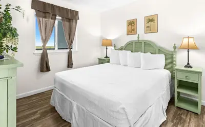 a bedroom with a white bed and two lamps at One Seagrove Place 1306 in Santa Rosa Beach