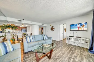 a living room with a couch and a table at One Seagrove Place 1306 in Santa Rosa Beach