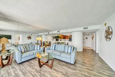 a living room with two couches and a table at One Seagrove Place 1306 in Santa Rosa Beach