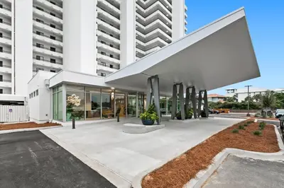 a large white building with a large white facade at One Seagrove Place 1205 in Santa Rosa Beach