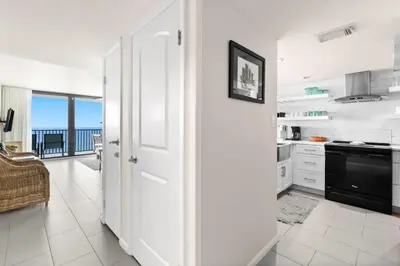 a white kitchen with a view of the ocean at One Seagrove Place 1503 in Santa Rosa Beach