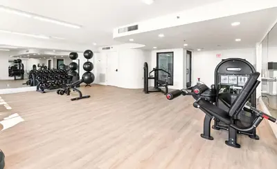 a gym with several treadmills and exercise bikes at One Seagrove Place 1503 in Santa Rosa Beach