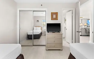 a bedroom with a television on a dresser with a bed at One Seagrove Place 0107 in Santa Rosa Beach