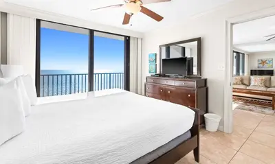 a bedroom with a large bed with a view of the ocean at One Seagrove Place 1507 in Santa Rosa Beach
