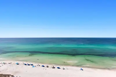 an aerial view of a beach with umbrellas and the ocean at One Seagrove Place 1507 in Santa Rosa Beach