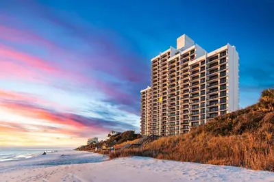 a tall building on the beach next to the ocean at One Seagrove Place 0201 in Santa Rosa Beach