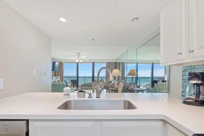 a kitchen with a sink and a view of the ocean at One Seagrove Place 0201 in Santa Rosa Beach