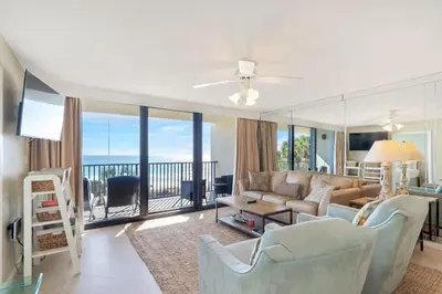 a living room with a couch and a balcony at One Seagrove Place 0201 in Santa Rosa Beach