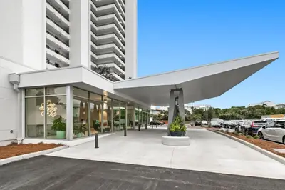 a large white building with a large awning at One Seagrove Place 0201 in Santa Rosa Beach