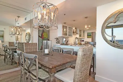 a dining room and kitchen with a table and chairs at One Seagrove Place 0205 in Santa Rosa Beach