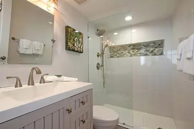 a bathroom with a shower and a sink and a toilet at One Seagrove Place 0205 in Santa Rosa Beach