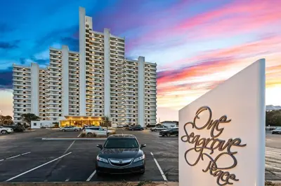 a car parked in a parking lot in front of a large building at One Seagrove Place 0403 in Santa Rosa Beach