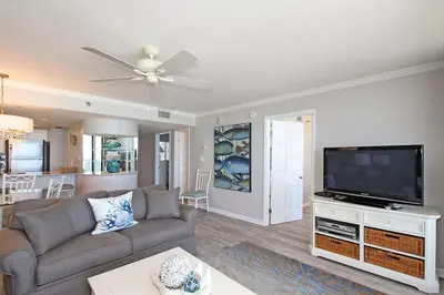 a living room with a couch and a flat screen tv at One Seagrove Place 0403 in Santa Rosa Beach