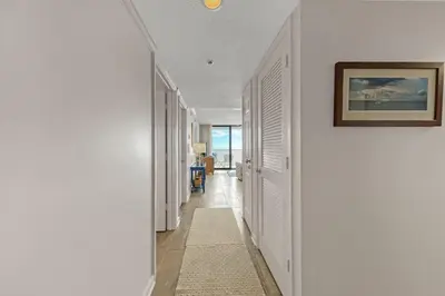 a hallway with white walls and a picture on the wall at One Seagrove Place 1508 in Santa Rosa Beach