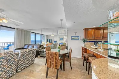 a kitchen and living room with a table and chairs at One Seagrove Place 1508 in Santa Rosa Beach