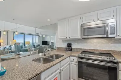 a kitchen with a sink and a microwave at One Seagrove Place 0202 in Santa Rosa Beach