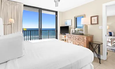 a bedroom with a bed and a view of the ocean at One Seagrove Place 0401 in Santa Rosa Beach