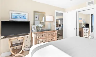 a bedroom with a bed and a flat screen tv at One Seagrove Place 0401 in Santa Rosa Beach